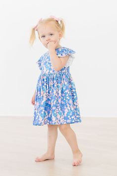 The perfect dress for school, special occasions, and everyday play! Designed by a mom and a dad. Mom wanted something twirly, comfortable and easy to wash. Dad wanted something easy to get on his chubby, big headed toddler. Designed with a scoop back for quick on and off, and higher neckline for modesty. Pair with Twirl Shorts or Leggings for the perfect everyday outfit. INSTRUCTIONS: Wear-Twirl-Repeat FIT - FABRIC - CARE: True to Size Model are wearing a size 2T & 7/8 95% Polyester/5% Spandex M Fitted Twirl Dress With Flutter Sleeves And Ruffles, Fitted Flutter Sleeve Twirl Dress With Ruffles, Flutter Sleeve Twirl Dress With Ruffles For Dress-up, Fitted Flutter Sleeve Twirl Dress For Dress-up, Summer Flutter Sleeve Twirl Dress For Dress-up, Dress For School, Mila Rose, Pom Pom Dress, Summer Tank Dress