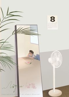 a mirror sitting on top of a wooden table next to a plant and a fan