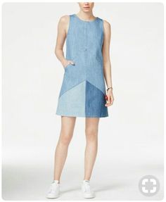 a woman in a denim dress with an asymmetrical design