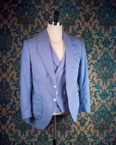 "ABOUT THIS STYLE: This style is inspired by the suits of the late 1920s and early 1930s. The sort of suit that you would throw on to go to the racetrack or a summer party. The jacket features a low lapel gorge, full lapels, and pleated patch pockets that are completely stitched by hand with handmade bartacks in the pocket corners. In our own era, this is the perfect suit for a summer wedding, whether you are the one getting married or are attending as a guest. THE MUSLIN FITTING PROCESS: The pr Classic Single Breasted Three-piece Suit For Spring, Classic Single-breasted Three-piece Suit For Spring, Pinstripe Suits With Welt Pockets And Lapel Collar, Pinstripe Single Breasted Suit With Lapel Collar, Pinstripe Single Breasted Suits With Lapel Collar, Pinstripe Single-breasted Suit With Lapel Collar, Summer Tailoring Blazer With Suit Collar, Spring Pinstripe Suits, Spring Vintage Tailored Suits