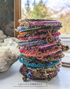 a stack of bracelets sitting on top of a table