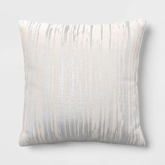 a white and grey striped pillow sitting on top of a table