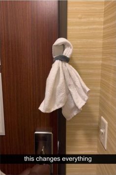 a white towel hanging on the side of a door