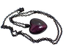 "Nice Goth heart design with black chain and setting. The resin cab is pearly black and dark pink with hints of purple.  Size: Chain is 24\" long. Pendant is 1 3/8\" x 1\" in size including the bail. Type: New, Handmade by Sharky.  Condition: Made with all new materials. Please note that handmade resin pieces may include small imperfections and slight differences in pattern and color. Materials: Black coated base metal, resin." Emo Heart-shaped Jewelry Gift, Emo Necklace For Valentine's Day Gift, Emo Style Necklace For Valentine's Day Gift, Floral Cuff Bracelet, Fantasy Necklace, Purple Resin, Gothic Pendant, Floral Cuff, Goth Necklace