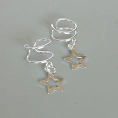 Star charm dangler, open ended sterling silver ear cuff. Dimensions: 6 x 8 mm Star: 8 x 8 Weight: .90gm Price listed is for ONE PIECE These are made of 925 hypoallergenic sterling silver. pieces come with a 925 stamp. Can be packaged in a gift box. I can include a personal message from you if needed You are welcome to contact me at... bhavnakwintra1956@gmail.com For more beautiful pieces from my shop, please browse 👇 TOE RINGS: https://www.etsy.com/your/shops/TheSilverGame/tools/listings/sectio Wrap Earrings, Silver Ear Cuff, Open Ended, Unisex Jewelry, Silver Pieces, Star Charms, Toe Rings, Personal Message, Ear Piercings