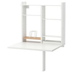 a white desk with shelves and a chair on it's side, in front of a white background