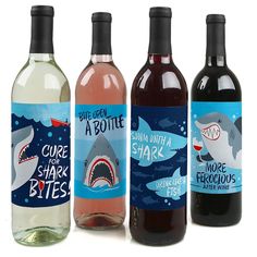 three bottles of wine with shark labels on them