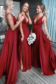 three beautiful women in red dresses standing next to each other