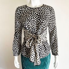 "Mint condition vintage J.Crew 100% silk blouse in a black and white leopard print with an attached sash that can be tied in the front or in the back wrapped around the waist like an obi for a bespoke fit . Pullover with silk covered button fastening in the back and two buttons on the cuffs. The contrasting black and white is versatile to match with a number of festive holiday colors for the upcoming holidays, Christmas, New Year's eve and more. The perfect natural, luxury fabric addition to your sustainable wardrobe and vintage clothing collection. The condition is excellent and no rips or stains. Flat measurements: Shoulder to Shoulder 15\" Pit to Pit 19\" Total length 24.5\" Sleeve length 21\" Mannequin measurements: 34\" - 26\" - 36\" Follow us on Instagram for previews and behind the Elegant Polka Dot Evening Top, Elegant Evening Polka Dot Top, Elegant Polka Dot Party Tops, Elegant Polka Dot Blouse For Party, Spring Party Blouse With Tie Waist, Elegant Polka Dot Party Blouse, Fitted Tie Waist Blouse For Party, Chic Polka Dot Blouse For Party, Chic Polka Dot Party Blouse