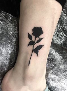 a black rose tattoo on the ankle