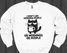 For those who prefer to be left alone in the morning: This funny sweatshirt featuring the 'I Don't Like Morning People' cat design is just what you need. Made from soft, cozy fabric, it's perfect for those quiet morning moments with your coffee - alone, of course! A great gift for morning haters and cat lovers who enjoy their solitude. Whether as a Christmas gift, birthday present, or just to make your point, this sweatshirt says it all! * 50% cotton, 50% polyester * Pre-shrunk * Classic fit * 1 Funny Morning, Quiet Morning, Morning People, People Funny, Cat Sweater, Funny Sweaters, Coffee Shirt, Cozy Fabric, Funny Sweatshirts