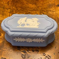 a blue box sitting on top of a wooden table