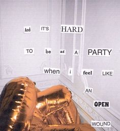 a gold foil balloon sitting on the floor in front of a wall with words written all over it