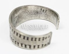 This beautiful Viking bracelet is historically accurate and modeled after a silver Viking bracelet found in the Curedale hoard at Lancashire, England in 1840. This type of stamped design was common in Viking culture, and solid silver bracelets such as this would have been used both as bullion and as jewelry. This particular bracelet we offer has been handmade of finely polished silver pewter and recreated from the archaeological find in every detail. The metal of this bracelet is completely safe Viking Style Silver Bangle Bracelet, Hand Forged Medieval Silver Jewelry, Medieval Style Adjustable Engraved Jewelry, Hand Forged Silver Medieval Jewelry, Hand Forged Silver Viking Jewelry, Medieval Engraved Bracelet Jewelry, Medieval Style Engraved Antique Silver Jewelry, Antique Silver Medieval Jewelry With Oxidized Finish, Medieval Jewelry In Antique Silver With Oxidized Finish