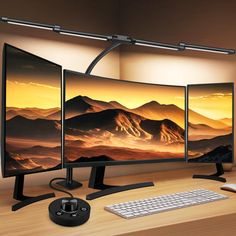 three computer monitors sitting on top of a wooden desk