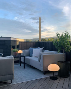 a couch sitting on top of a wooden deck