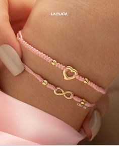 two bracelets that have hearts on them and one has a gold plated heart