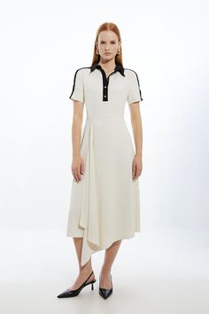 Feel Preppy In Our Midi Dress, Made In Crepe Fabric, With A Fitted Silhouette In The Bodice, With A Collar Accent, And A Flared Skirt Which Features An Asymmetric Hemliine. Style It Simply With Loafers Or Heels For A Look That Will Take You From Date Nights To Office Days. Soft Tailored Crepe Button Detailed Midi Dress High Quality Crepe Fabric Flattering Figure Hugging Bodice Flared, Asymmetric Skirt Unique Shirt Illusion Bodice Formal, Wide Collar Accent Button Detailing At Bust And Shoulders Collared Viscose Dress For Summer, Summer Collared Viscose Dresses, Chic Viscose Dress With Button Closure, Elegant Summer Midi Dress With Placket, Collared Viscose Summer Dress, Tailored A-line Dress With Buttons, Semi-formal Short Sleeve Dress With Placket, Elegant Viscose Dresses With Buttons, Collared Cream Dress For Work