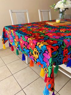 "Beautiful Mexican style tablecloth, to decorate Mexican parties, Mexican baby showers, May 5 party, Mexican weddings or for any occasion. Elegant and sophisticated, this tablecloth will create a stunning atmosphere in your kitchen, dining room or bedroom thanks to its vibrant colors. Perfect for everyday wear or special occasions. 100% polyester. Mexican fabric with floral print. The edges are folded and stitched. The end of each end has pompoms all around it (as the photo shows and if you want Mexican Colors Kitchen, Rustic Mexican Home Decor, Mexican Dining Room, Mexican Cafe, Mexican Decorations, Mexican Parties, Mexico Decor, Modern Mexican Home, Mexico Christmas