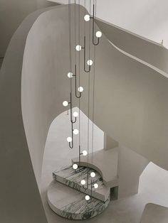 a spiral staircase with many lights hanging from it