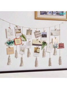 a bulletin board with pictures and tassels attached to it