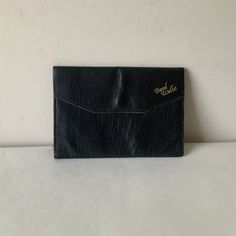 Vintage black leather travel wallet from the 50s/60s. Opens with a press stud fastening under front flap. Foil markings and spaces for passport, currency, travellers cheques, tickets, baggage checks. Real leather, made in England. Closed size 7 x t inches. Good vintage condition.  For more vintage clothes and accessories, visit my shop https://www.etsy.com/uk/shop/coolclobber Vintage Travel Wallets With Coin Pocket, Vintage Business Wallet With Coin Pocket, Vintage Travel Wallet With Coin Pocket, Vintage Wallets With Coin Pocket For Business, Vintage Rectangular Business Wallet, Vintage Card Holder With Interior Slots, Vintage Black Wallet For Travel, Vintage Black Travel Wallet, Vinyl Frames