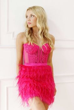 A fun and flirty mini with a feather skirt and bustier top.