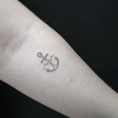 a small lizard tattoo on the left forearm and arm, with an arrow in the middle