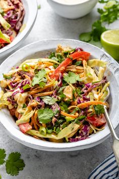 two white bowls filled with salad and garnished with cilantro