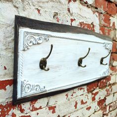 the coat hooks are attached to the brick wall