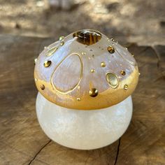 a white and gold object sitting on top of a wooden table