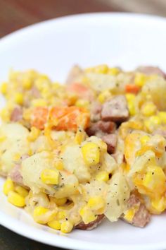 a white plate topped with corn and potatoes