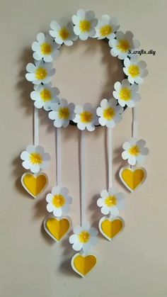 paper flowers and hearts hanging from strings