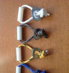 several different types of keys and cords on a brown surface with one knot tied to the end