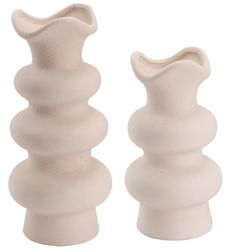 two white vases sitting next to each other