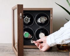 Crafted to cater to your timepiece needs, our watch winder collection embraces sophistication in three sizes: the sleek 1-slot, the versatile 2-slot, and the spacious 4-slot.  Designed for watch aficionados, each winder boasts precision engineering to ensure your automatic watches are meticulously wound, maintaining their accuracy and longevity. With a seamless blend of functionality and aesthetics, these winders feature customizable settings, accommodating diverse watch sizes and winding specif Modern Automatic Watch Accessories For Gifts, Luxury Self-winding Watch As A Gift, Modern Watches With Round Case As Gift, Modern Watch Accessories With Subdials As Gift, Timeless Self-winding Watch Accessories As Gift, Watch Gift Box, Watch Holder, Watch Storage, Watch Winder