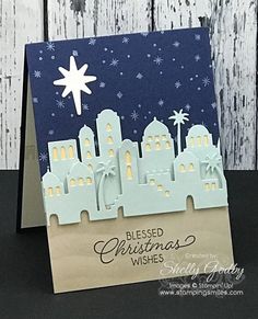 a handmade christmas card with a city scene