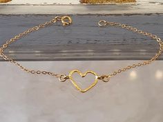 Elegant and delicate dainty heart bracelet, made of high quality 24K Gold plated heart and Rollo chain, In the heart there are slight touches of flattening for a sleek and elegant look  Beautiful  and lovely bracelet with love meaning  suitable to give as a gift to every special  girl, woman, fiance, bride who loves * Free Shipping About me: https://www.etsy.com/il-en/people/rutyawpaloma Heart Bracelet Gold, Love Meaning, Gold Heart Bracelet, Jewelry Delicate, Bracelet Heart, Special Girl, Love Is Free, Bracelet Gold, Gold Heart