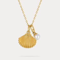 This delicate pearl and gold shell pendant necklace speaks volumes on sustainable style.  Featuring a genuine freshwater pearl nestled within a 9k gold-plated shell, this dainty necklace captures the ocean's essence in an eco-friendly design. Perfect for the conscious consumer, this necklace adds a touch of delicate charm and aquatic inspiration to any outfit. 🌊 DETAILS Plating: 9K Gold  Materials: 9K Gold on Silver, Freshwater Pearl Measurements: Length: 15.75 "(40cm) + Extender: 1.97"(5cm) Pendant Size: 0.47"*0.71"(1.2cm*1.8cm) Weight: 3.1 g Yellow Gold Charm Necklace With Pearl Drop, Elegant Gold Shell Necklace With Pearl Charm, Elegant Gold Shell Necklace With Pearl Drop, Dainty Shell-shaped Necklace With Pearl Charm, Gold Shell With Pearl Drop, Elegant Gold Shell Necklace With Pearl Pendant, Yellow Gold Charm Necklace With Pearl Pendant, Yellow Gold Pearl Pendant Charm Necklace, Pearl Charm Pendant Shell As Gift