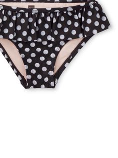 Black-and-white and cute all over, our polka dotted ruffle bikini bottom pairs swimmingly with a Tea tankini or swim top. A fitted poly/spandex blend gives the perfect amount of stretch. Bonus design details: a cozy fully-lined interior, elastic drop waist, and UPF 40+ for sun protection. Polka Dot Swimwear For Summer, Playful Fitted Ruffle Swimwear, Playful Fitted Swimwear With Ruffles, Polka Dot Swimwear For Summer Swimming, Black Ruffled Stretch Tankini, Black Stretch Ruffle Tankini, Black Stretch Tankini With Ruffles, Polka Dot Tankini For Swimming Beachwear, Playful Ruffled Tankini For Pool