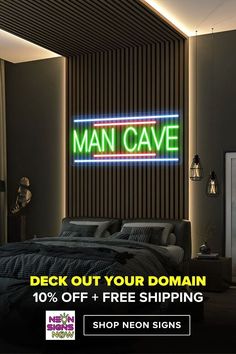 a man cave sign in the corner of a room with a bed and pillows on it