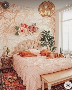 a cat laying on top of a bed in a room with floral wallpaper and rugs