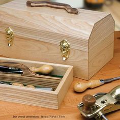 a wooden box sitting on top of a table filled with tools