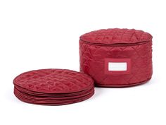 a set of four red quilted round storage baskets with labels on the front and back