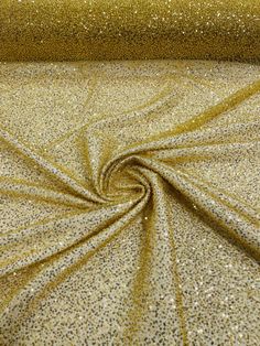 gold glitter fabric with small dots on the top and bottom, as well as a large amount