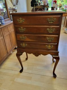 an antique chest of drawers in a room