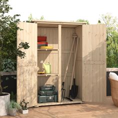 a garden shed with its doors open and gardening tools in the storage area next to it