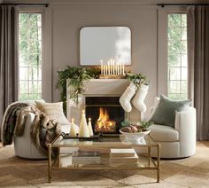 a living room filled with furniture and a fire place in front of a christmas tree