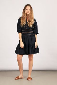 Elevate your style with our Mercy Dress – a blend of elegance and comfort. Crafted from 100% cotton, this mini dress is available in striking blue and classic black. The pleated ruffled skirt adds a playful touch, while the elasticated belt with contrasting stitching details defines your silhouette. Make a statement in our Mercy Dress! Size & Fit Fits true to size, take your normal size Designed to be worn loosely fitted Model is 5’10’’ (1.75 mt) and is wearing a size S Detalis & Care 100% cotton Mini dress Shirt collar V-neckline Buttons on chest to the waist Elasticated belt with stitching details in contrasting colours Long sleeves with detail on dropped shoulders Elasticized cuffs Pleated ruffled skirt Machine wash cold, do not bleach, tumbly dry gentle