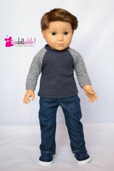 the doll is wearing jeans and a sweater with a striped sleeveless shirt on it